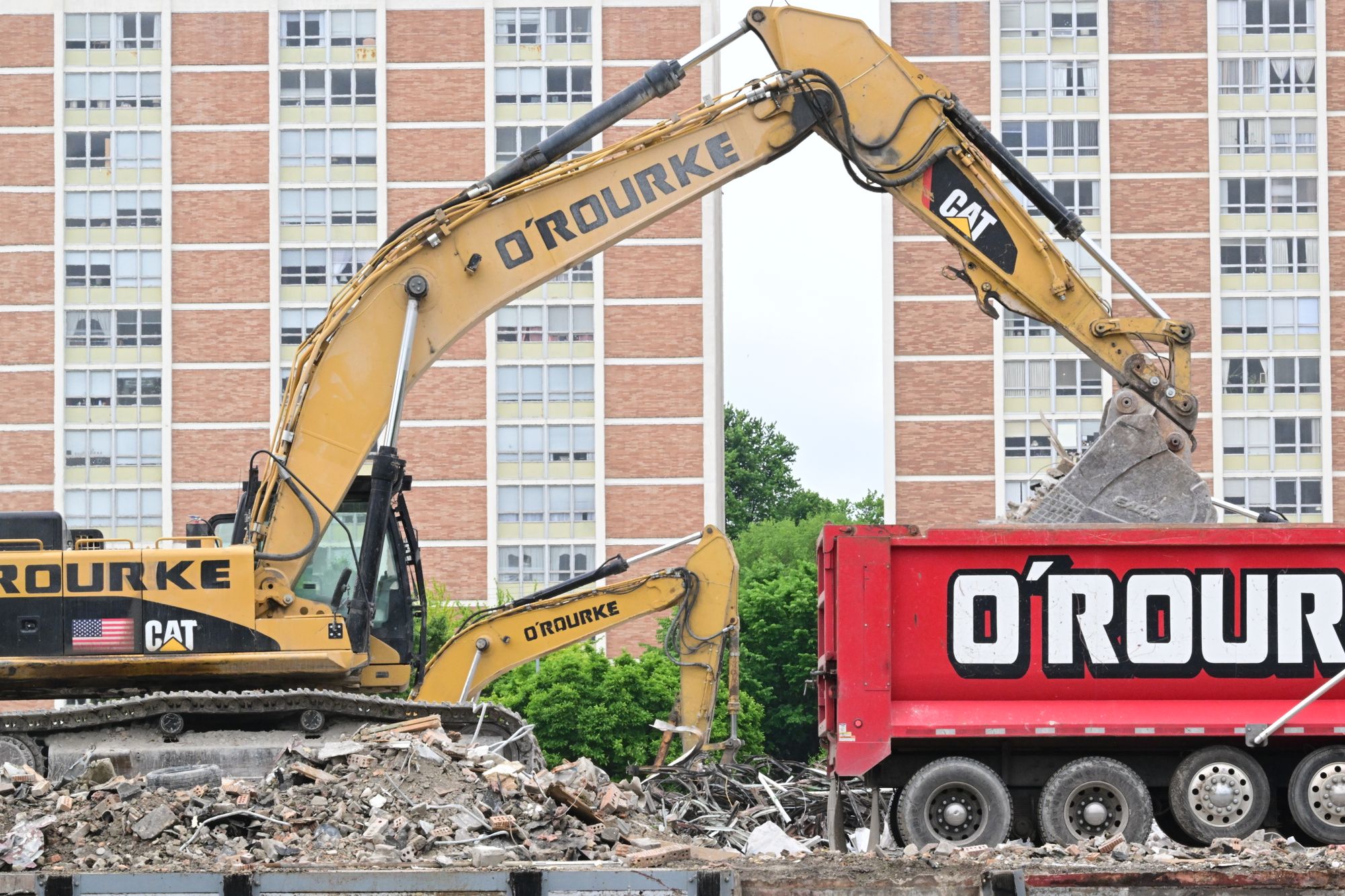 Excavator loading debris into a dump truck